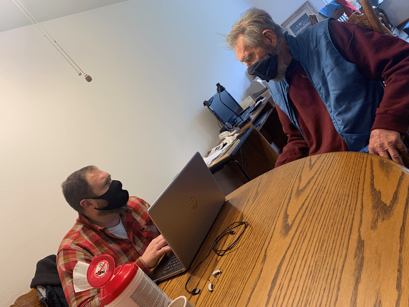 dustin dove and patient having a conversation around a table